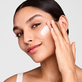photo of estee lauder model applying morning skincare routine